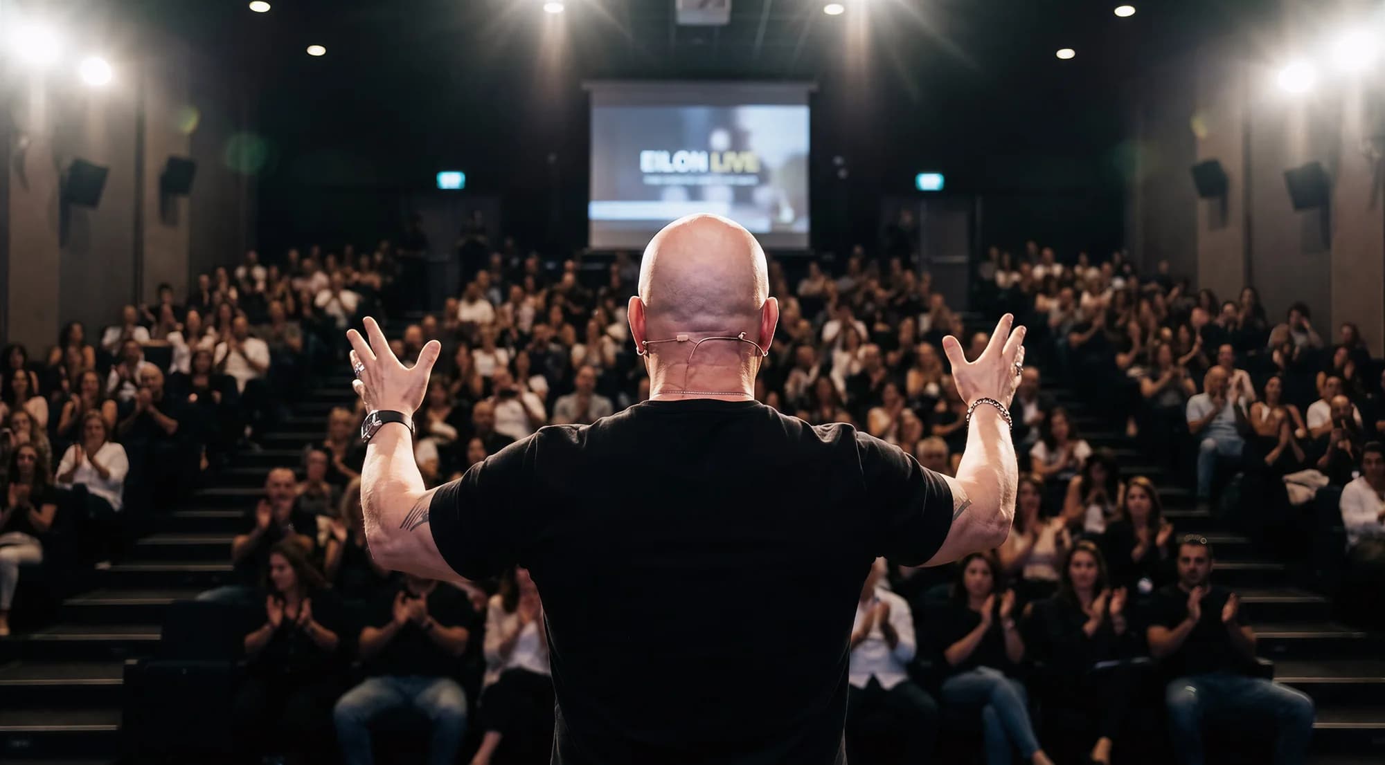 Eilon on stage in front of a live audience